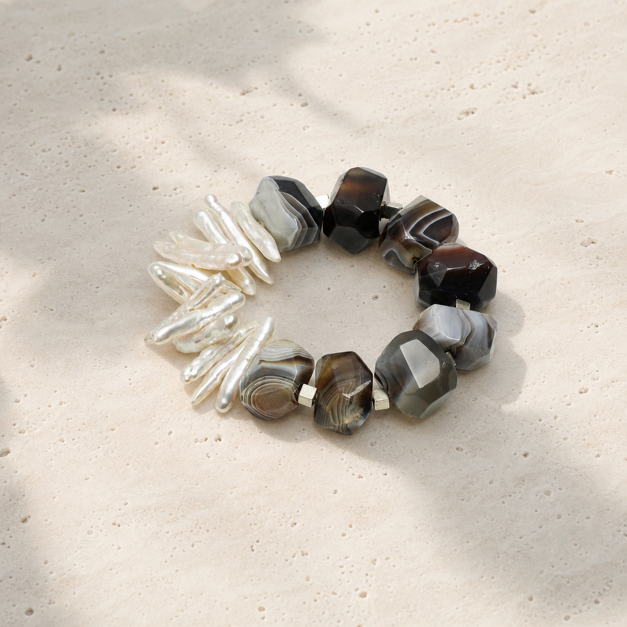 Agate baroque pearl branch bracelet on a warm ivory studio background