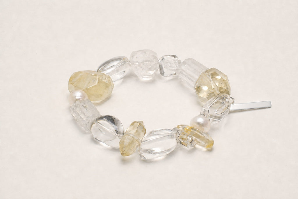 Citrine and clear quartz double-point bracelet shown from a low alternate angle