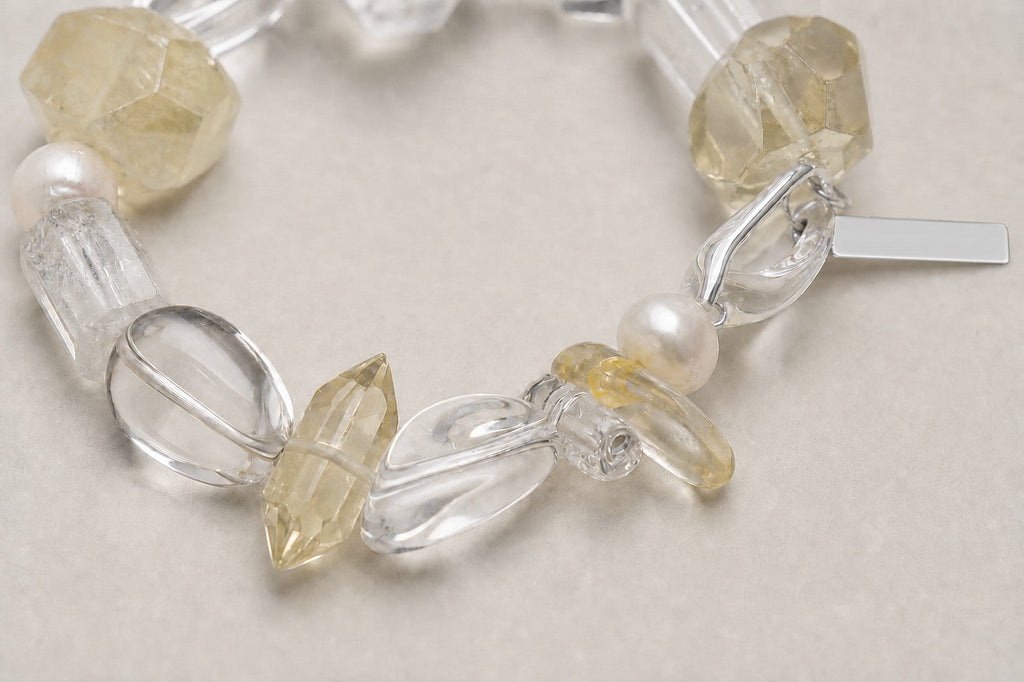 Close-up of double-point citrine, clear quartz, pearl and sterling silver bracelet workmanship