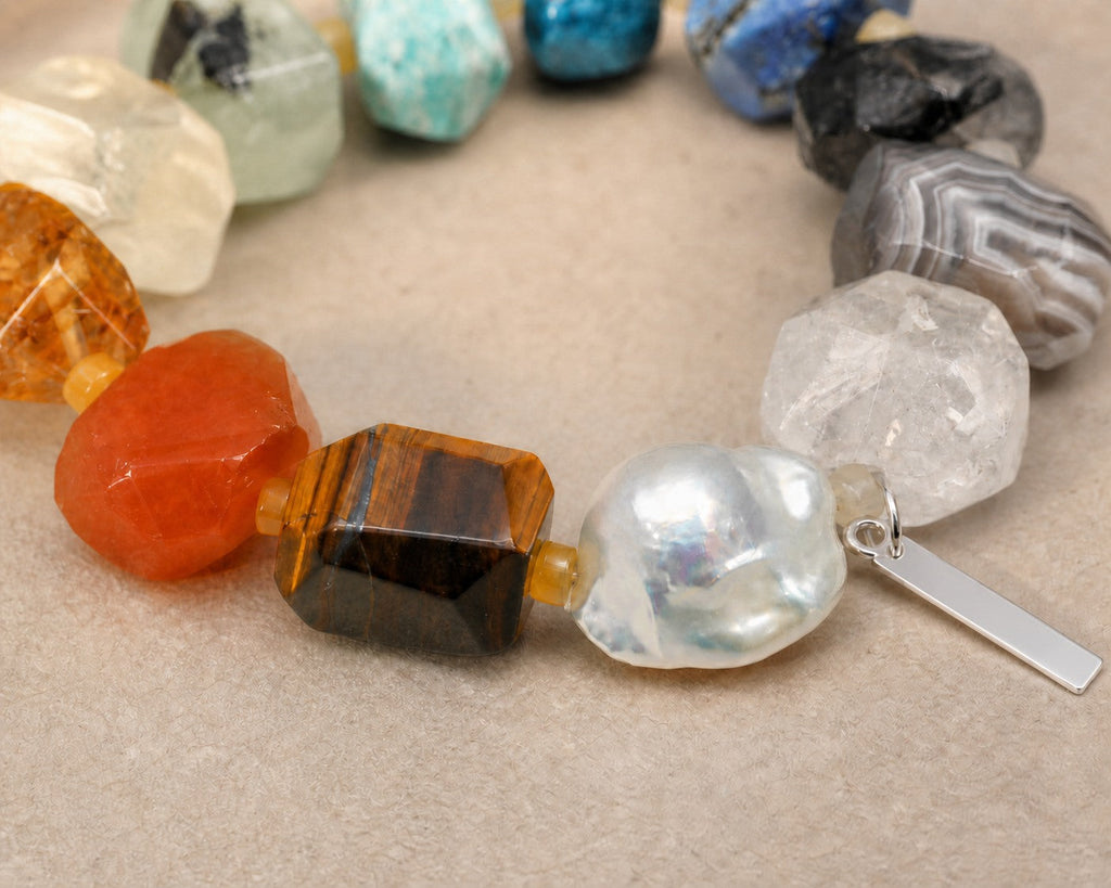 Close-up of citrine, clear quartz, tiger's eye, pearl and sterling silver bracelet workmanship