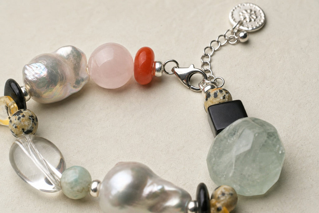 Close-up of clear quartz, green quartz, pearls and sterling silver bracelet clasp workmanship