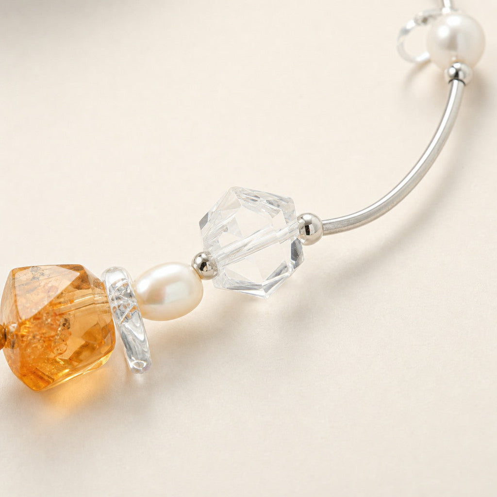 Close-up of citrine, clear quartz, pearls and sterling silver necklace workmanship