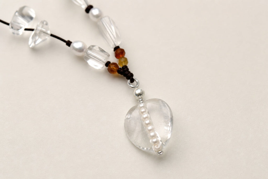 Close-up of citrine, clear quartz, rose quartz and sterling silver necklace workmanship