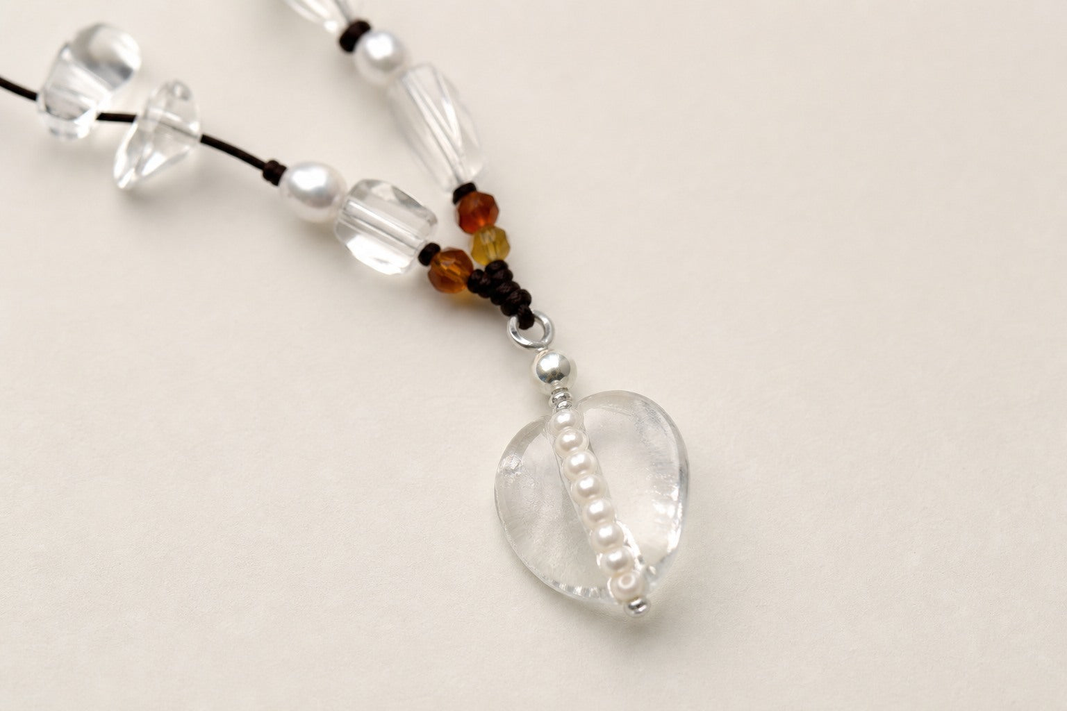 Close-up of citrine, clear quartz, rose quartz and sterling silver necklace workmanship