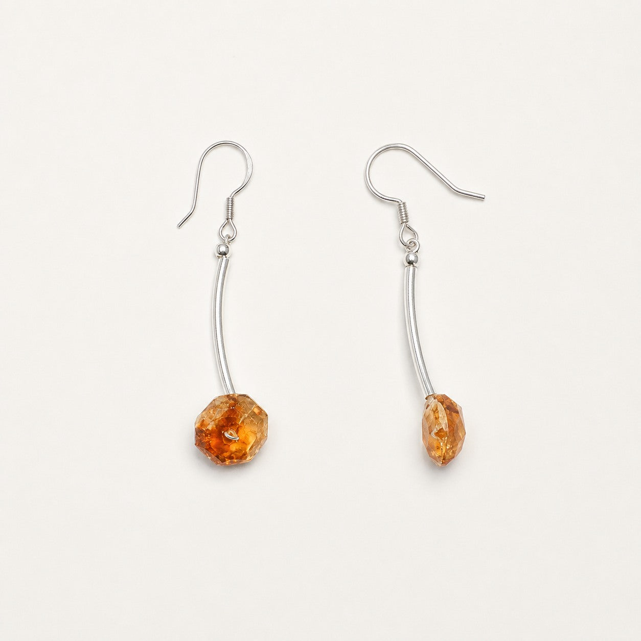 Pair of citrine faceted drop earrings shown from front and side angles
