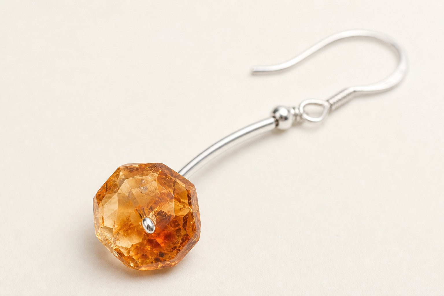 Close-up of faceted citrine and sterling silver earring construction