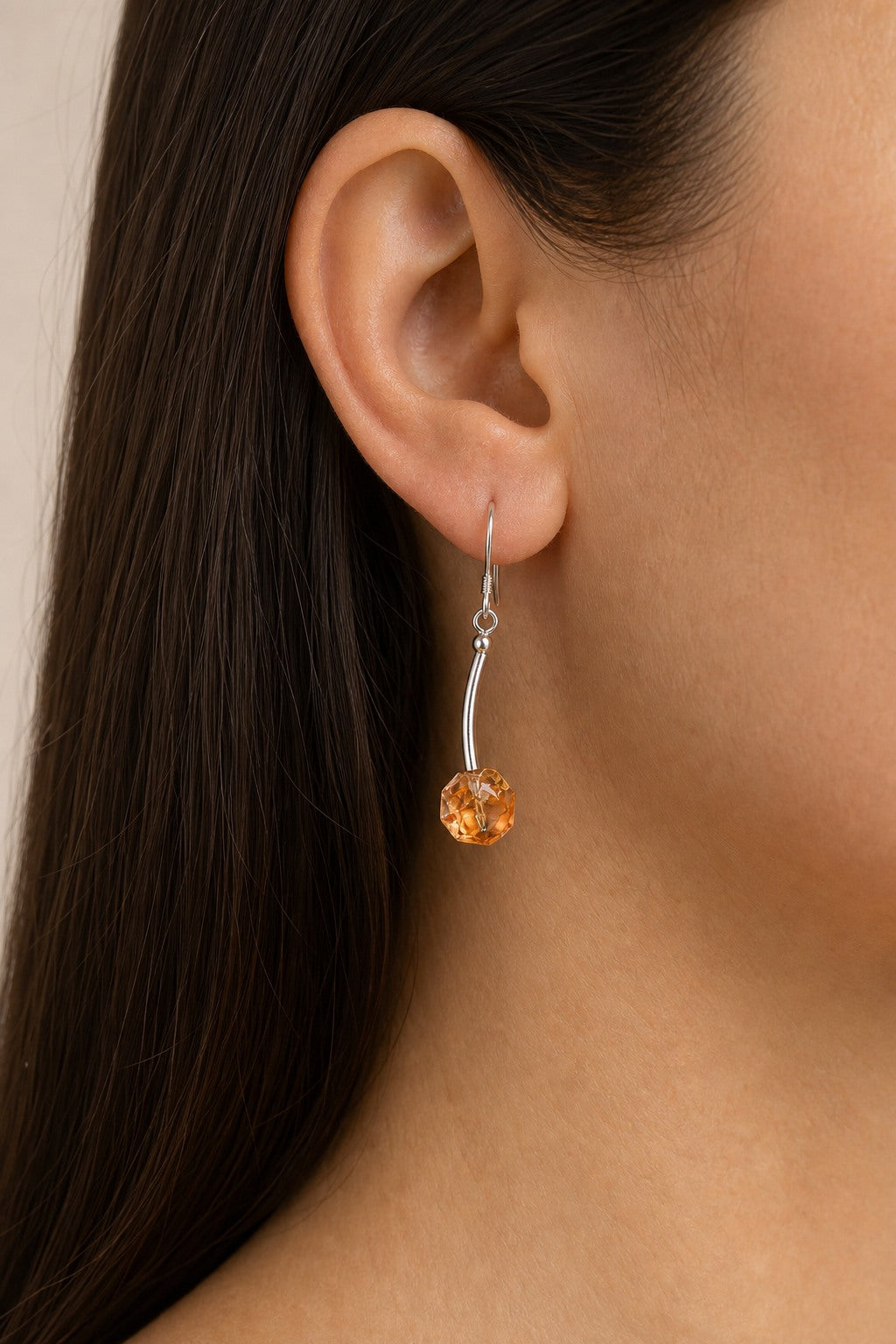 Citrine faceted drop earring worn through the ear at realistic 5.5 cm scale