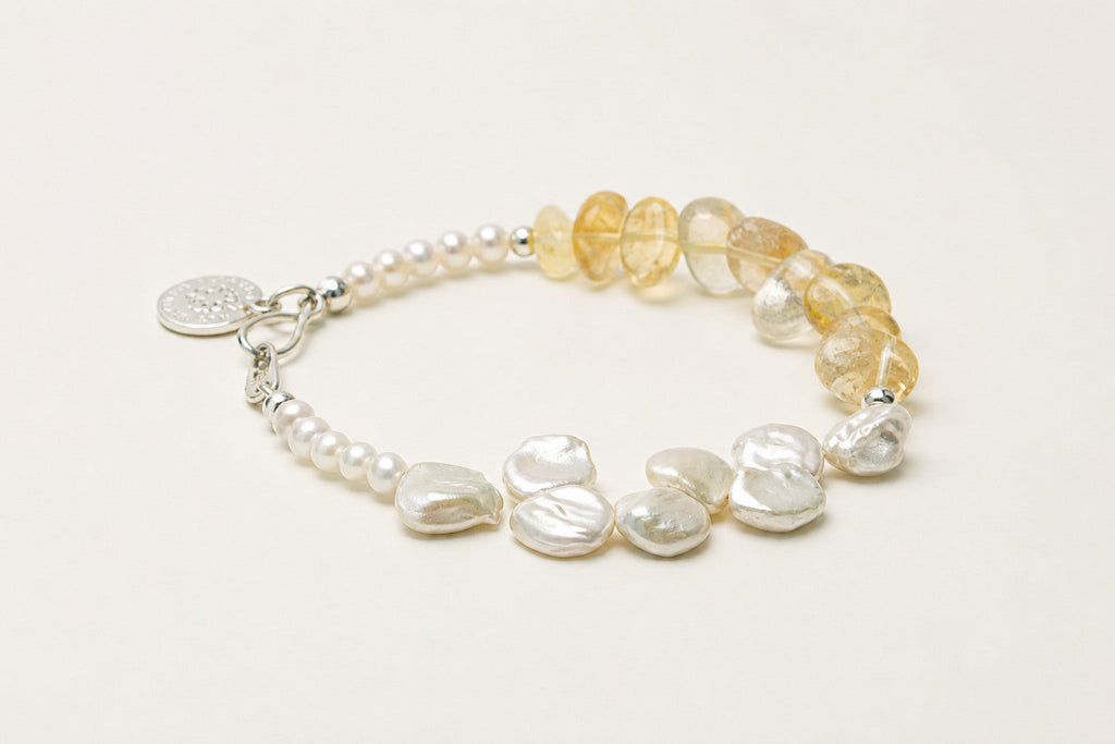 Citrine and freshwater pearl bracelet shown from a low alternate angle with its structure visible