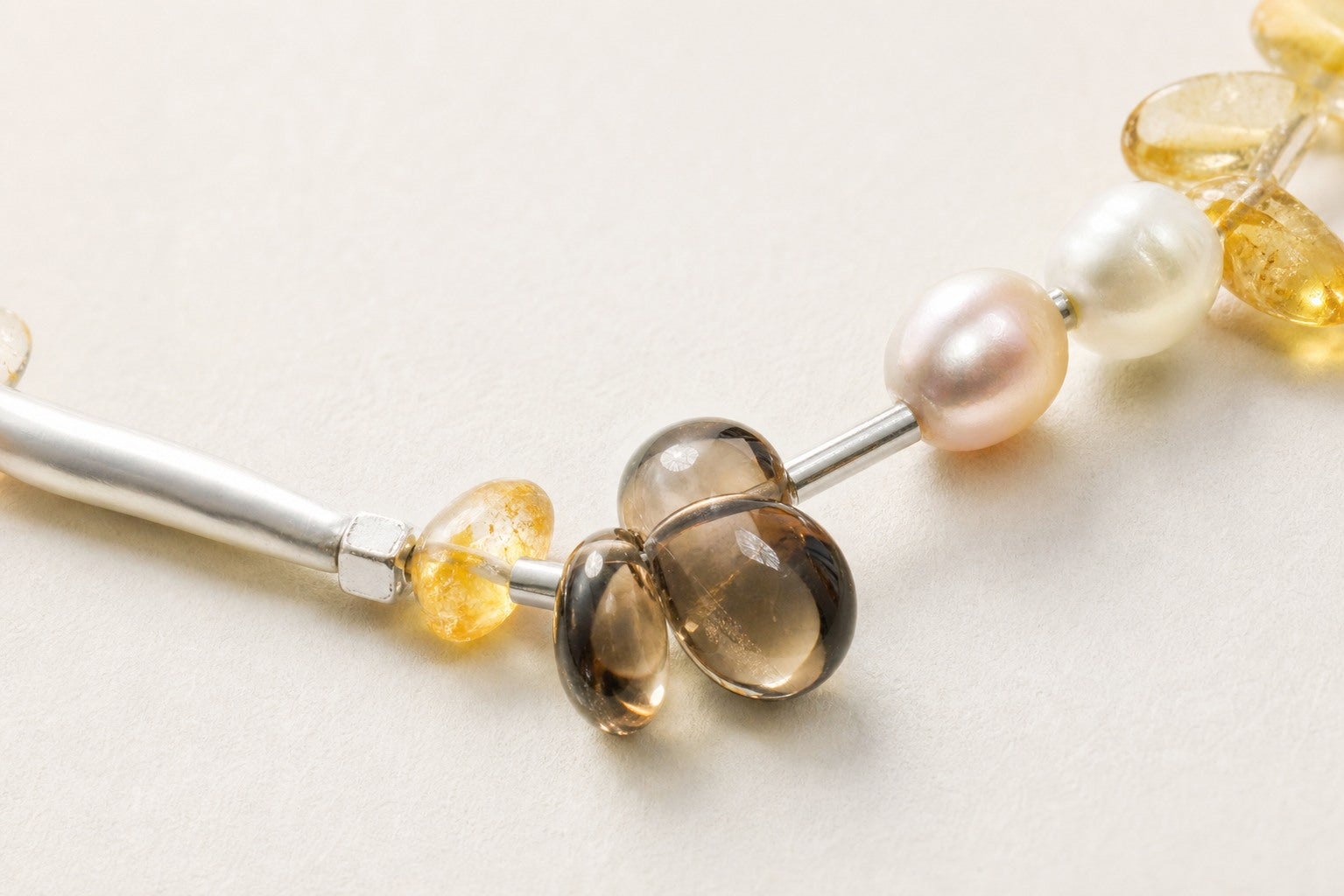 Close-up of the natural stones, freshwater pearls and sterling silver necklace workmanship