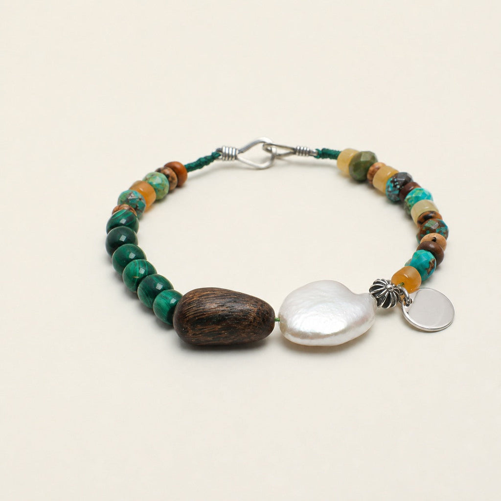 Citrine, malachite and turquoise bracelet shown from a low alternate angle with hook closure