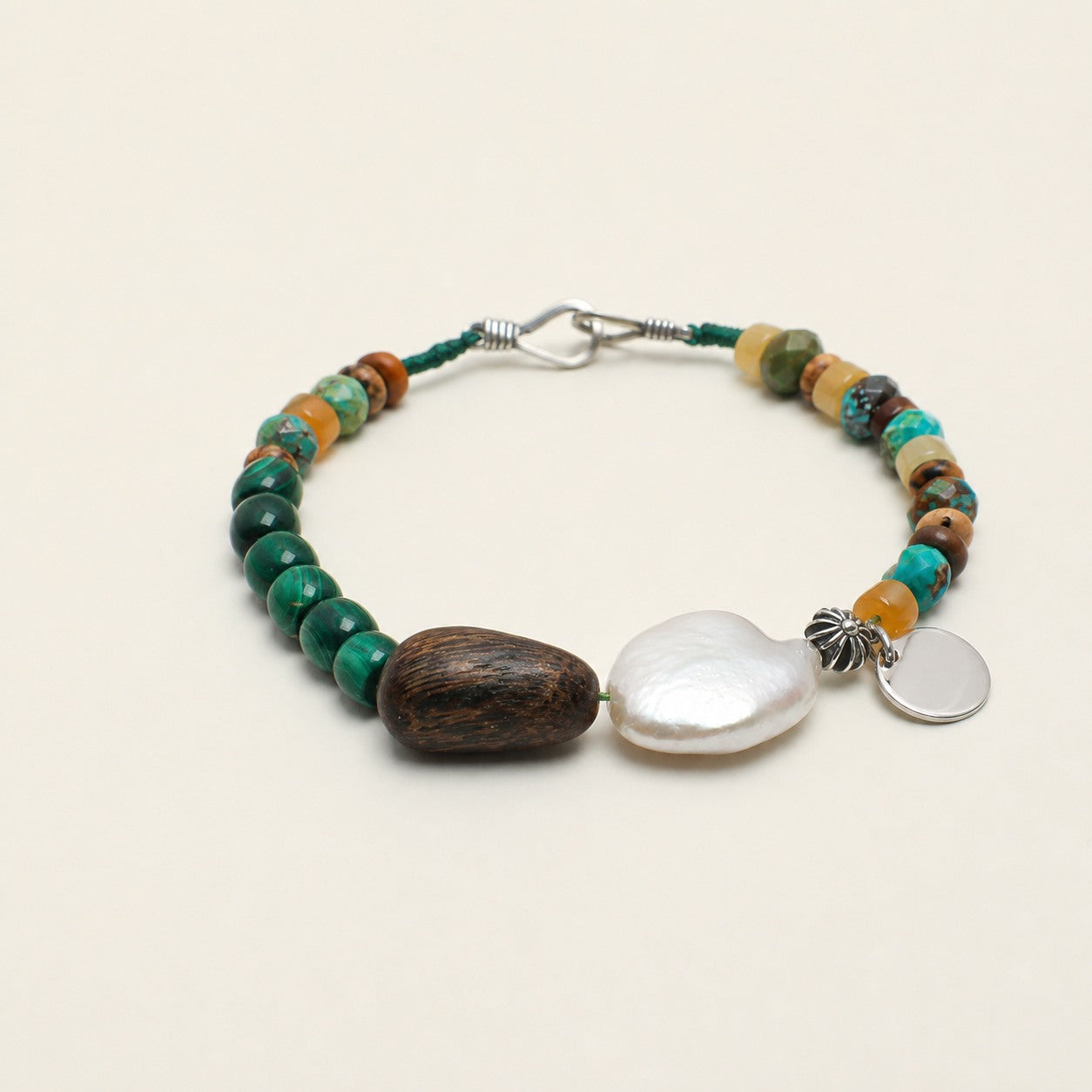 Citrine, malachite and turquoise bracelet shown from a low alternate angle with hook closure