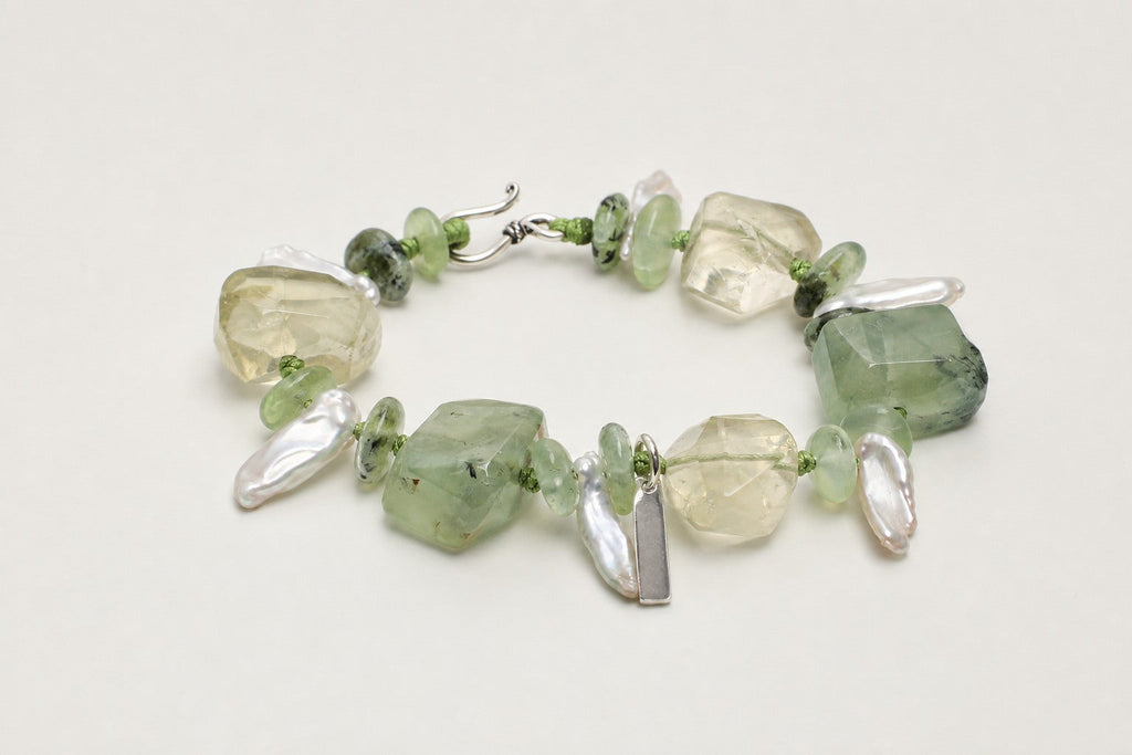 Citrine and prehnite freeform bracelet shown from a low alternate angle with hook closure