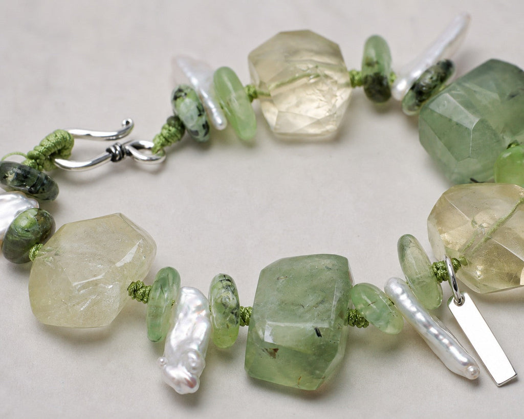 Close-up of citrine, prehnite, baroque pearls and sterling silver bracelet workmanship