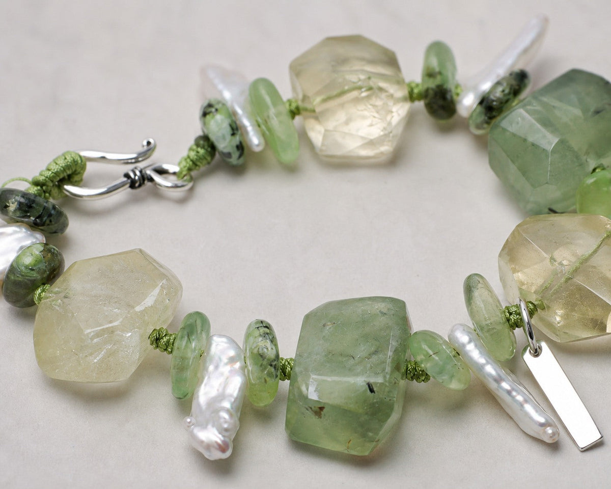 Close-up of citrine, prehnite, baroque pearls and sterling silver bracelet workmanship