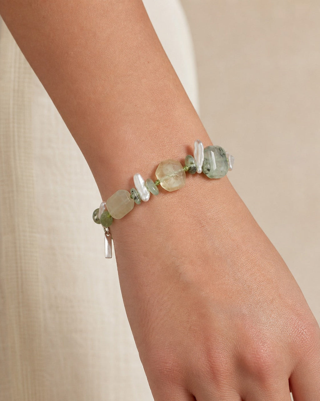 Citrine and prehnite bracelet with baroque pearls worn securely around the wrist