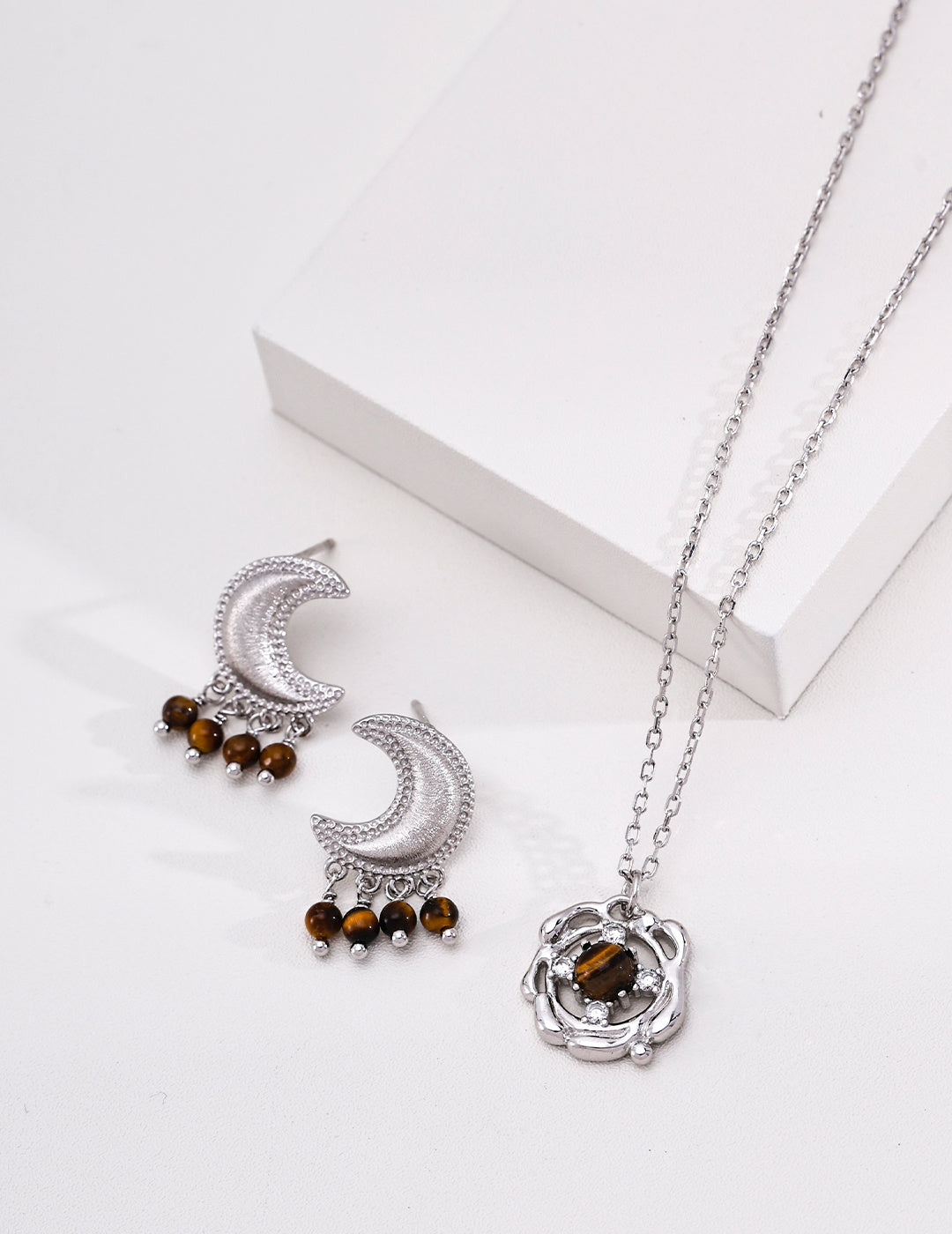 Tiger's eye crescent earrings styled with a separate matching necklace