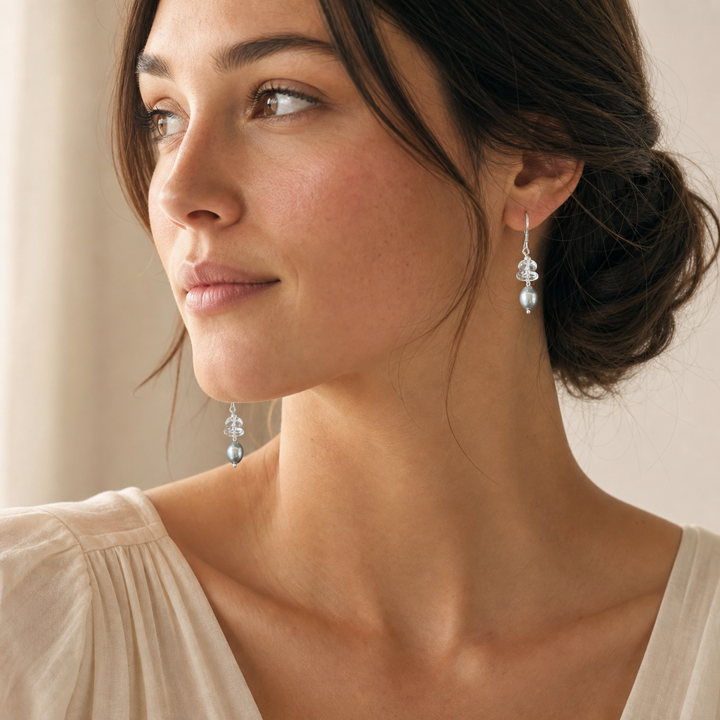 Model wearing crystal grey pearl drop earrings in soft natural light