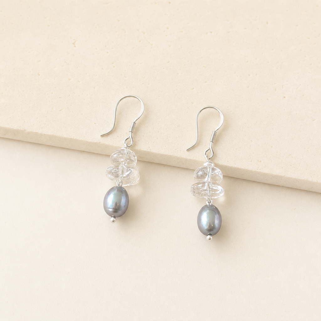 Crystal grey pearl drop earrings with clear crystal chips on an ivory studio background