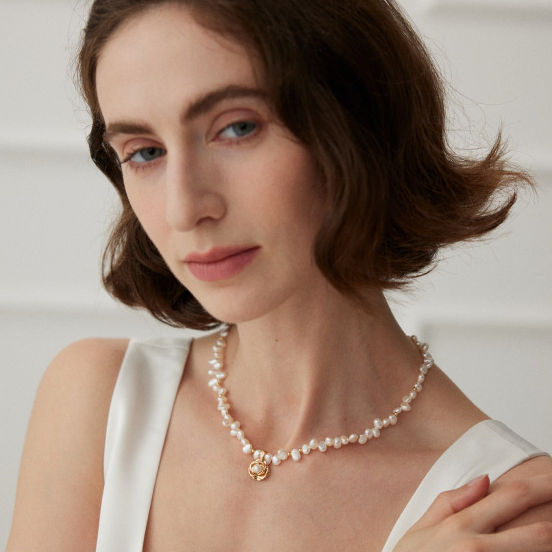 Front view of a model wearing the camellia pearl necklace
