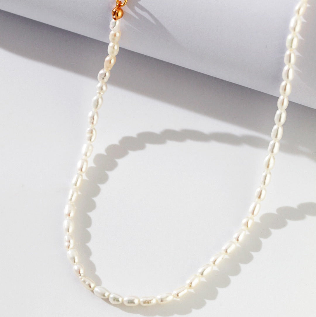Close-up of rice pearls and the gold-tone extension chain
