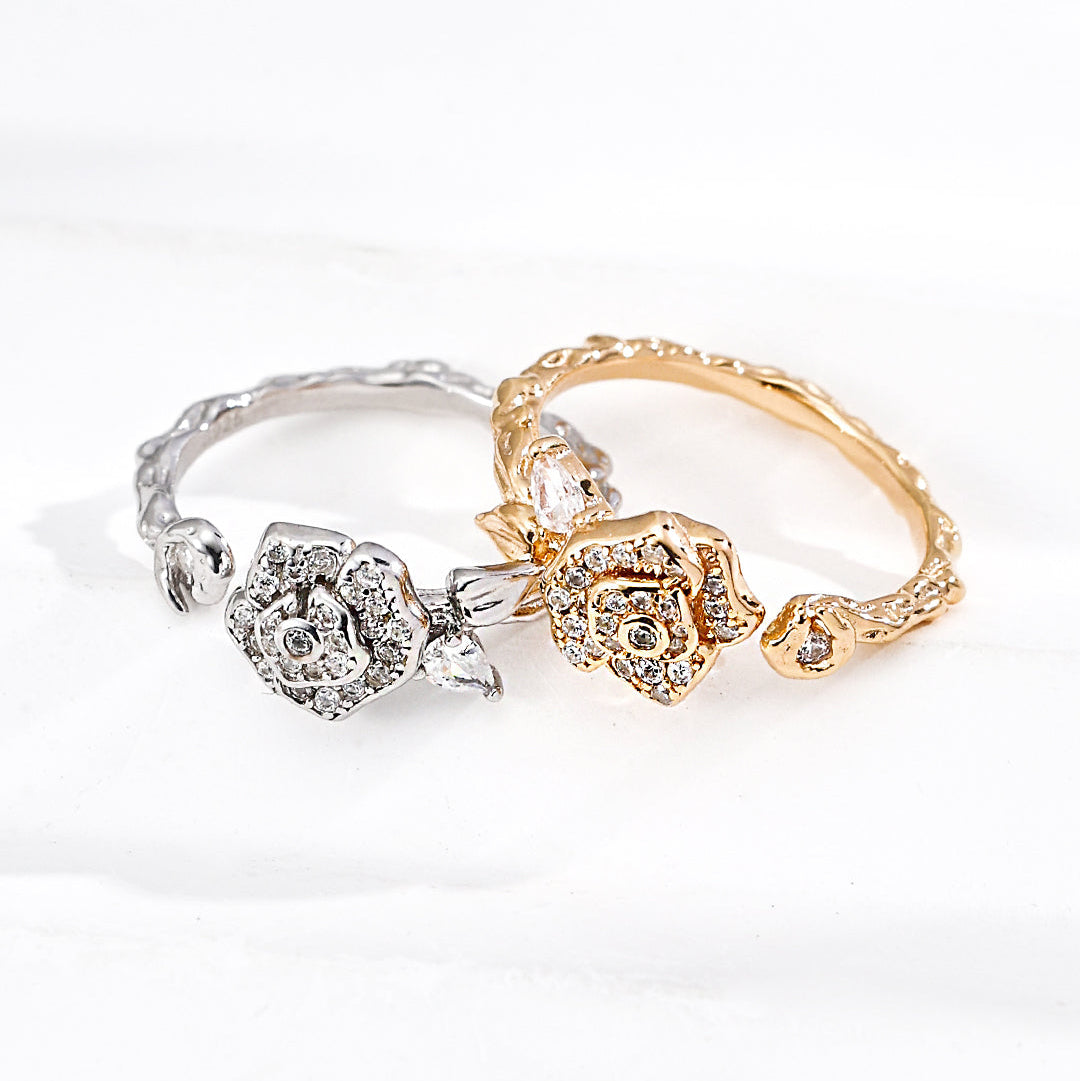 Gold-tone and platinum-tone camellia rings shown together