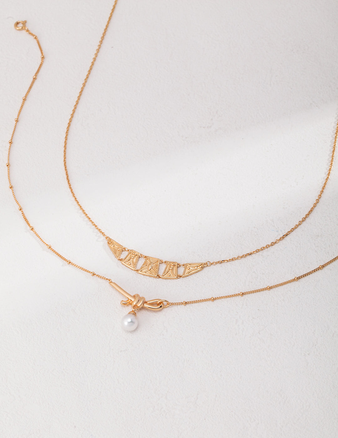 Knotted Pearl Drop Necklace — detail or styling view; other jewelry sold separately