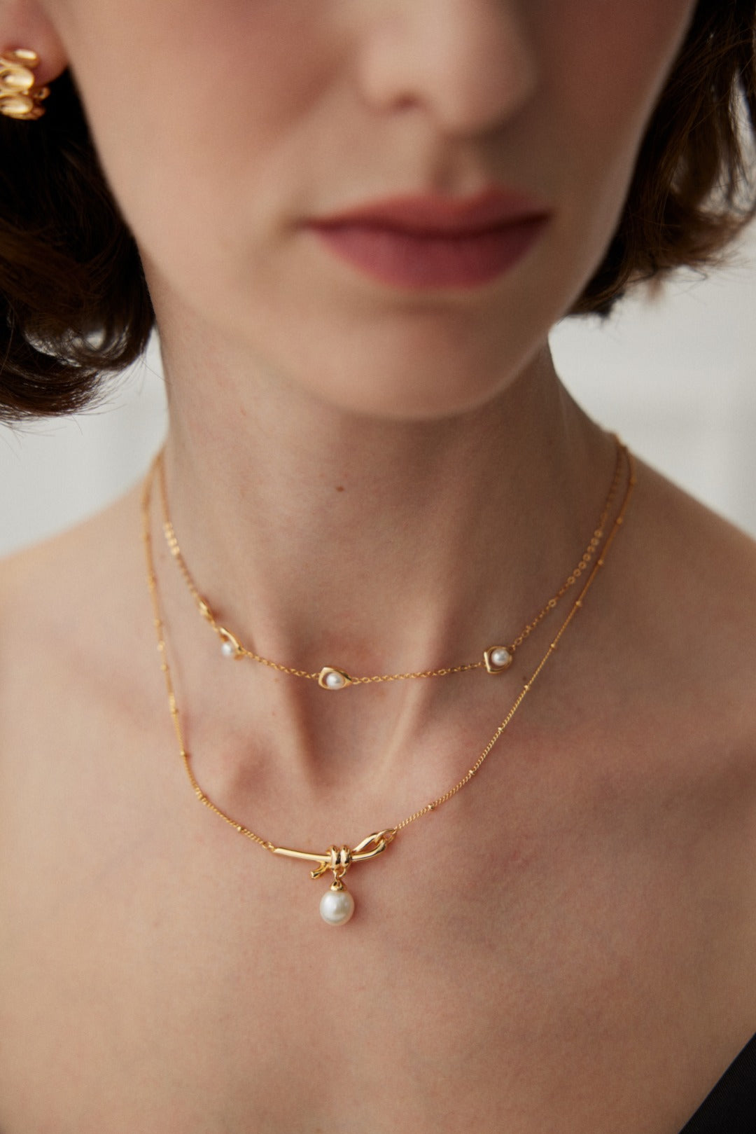Knotted Pearl Drop Necklace — detail or styling view; other jewelry sold separately