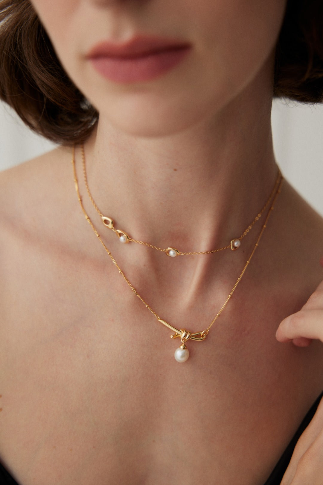 Knotted Pearl Drop Necklace — detail or styling view; other jewelry sold separately