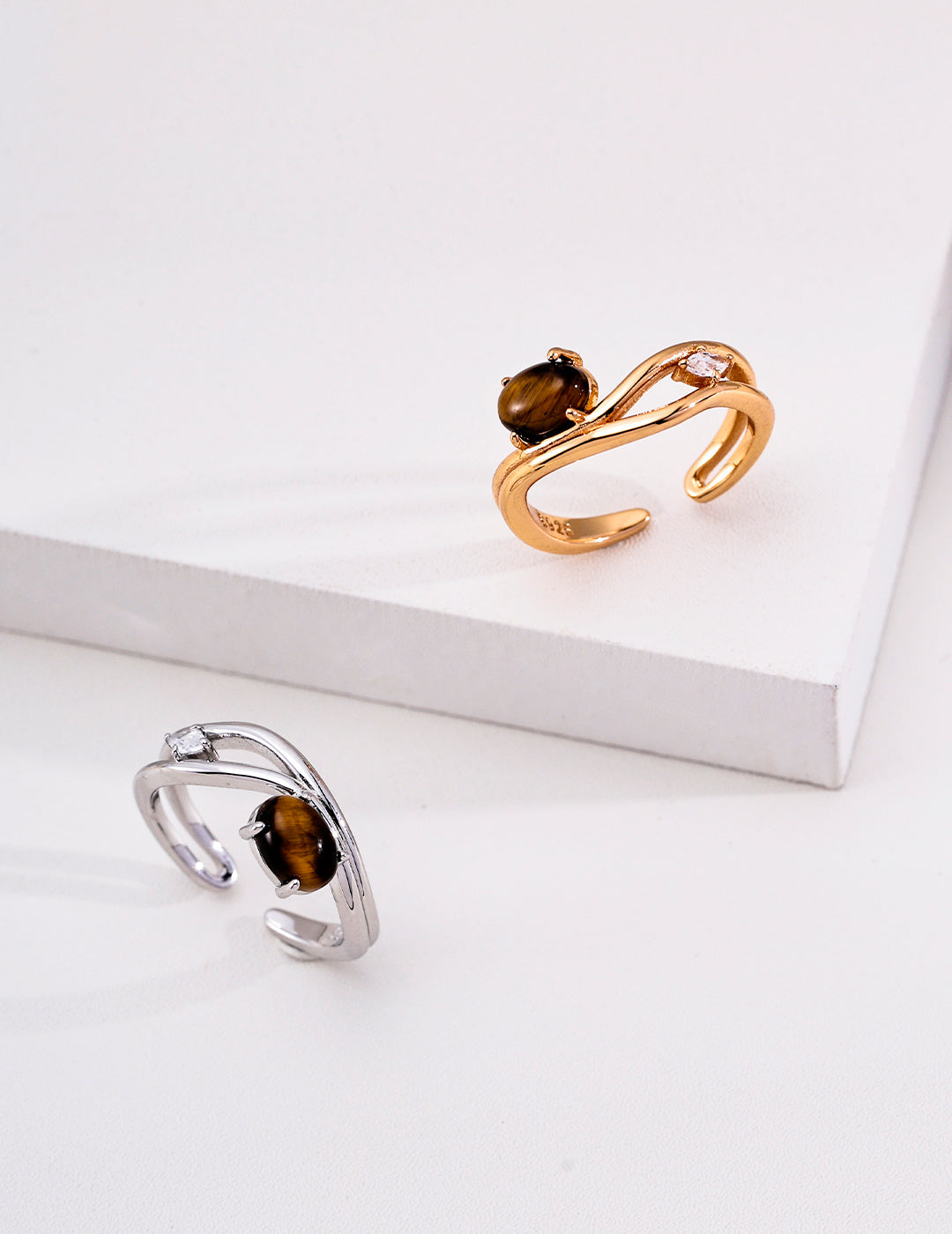 Tiger's eye oval crossover rings in silver and vintage gold tones
