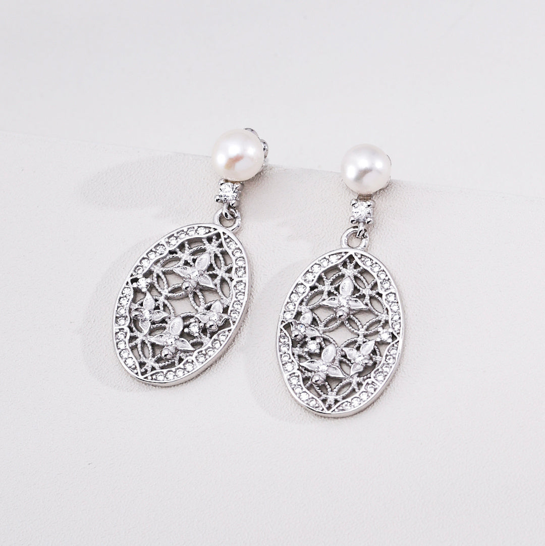 Silver-tone pearl earrings with oval filigree drops