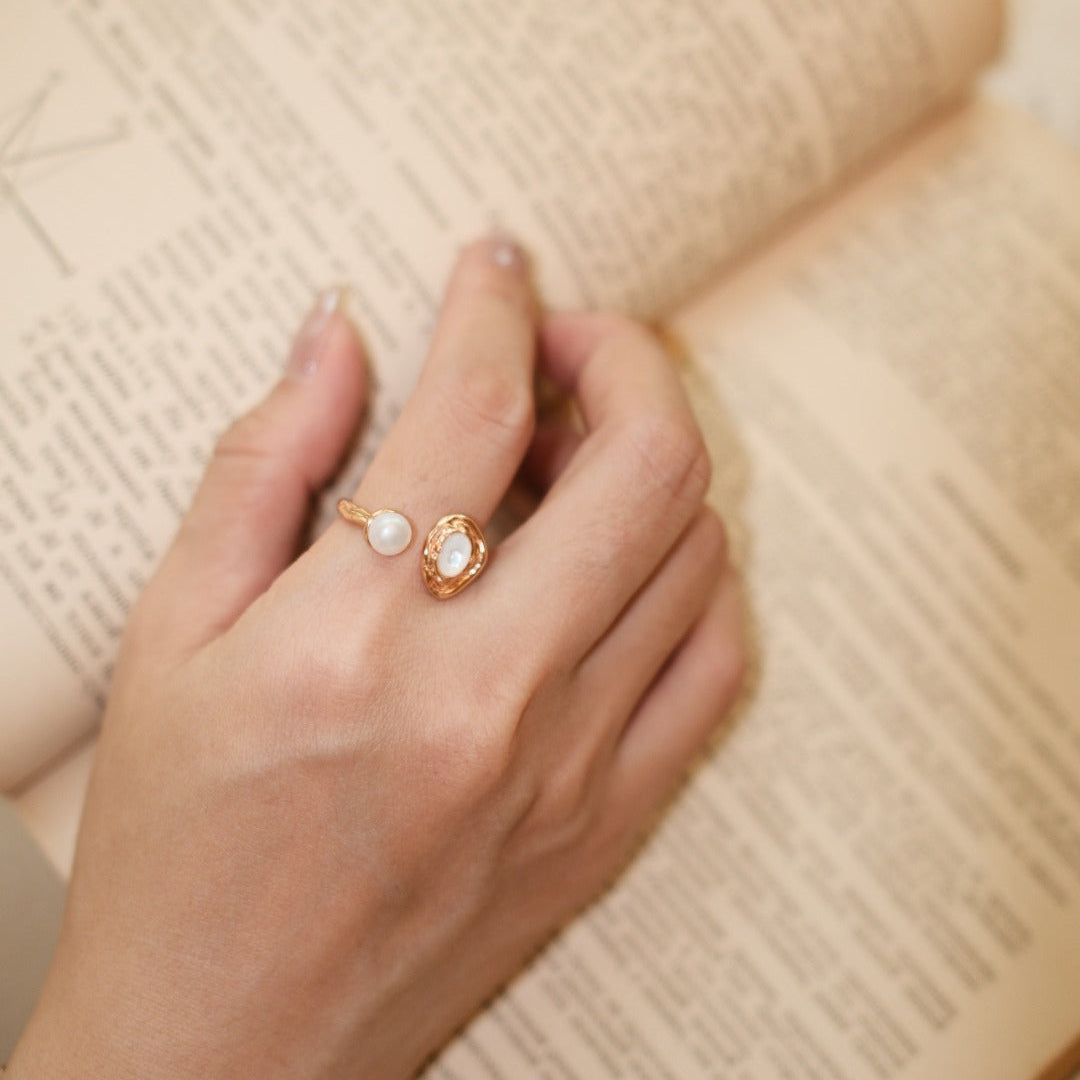 Close-up of the pearl open ring worn on a hand