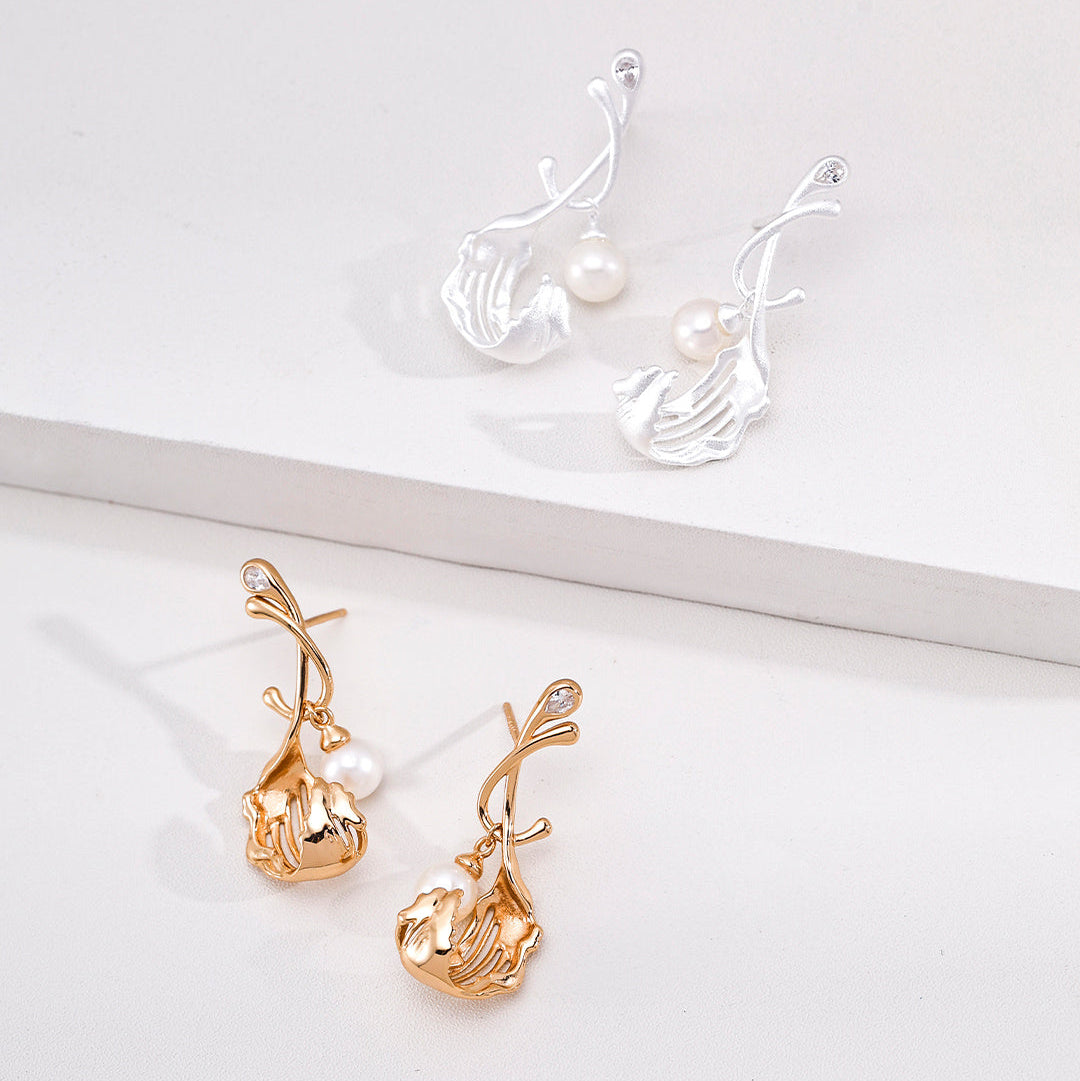 Pearl drop earrings with sculptural silver and vintage gold-tone stems