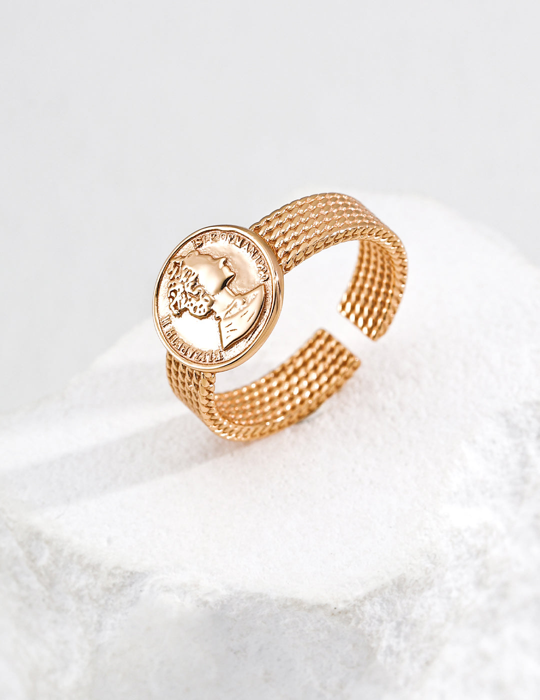 Close-up of the portrait medallion and woven-texture ring band