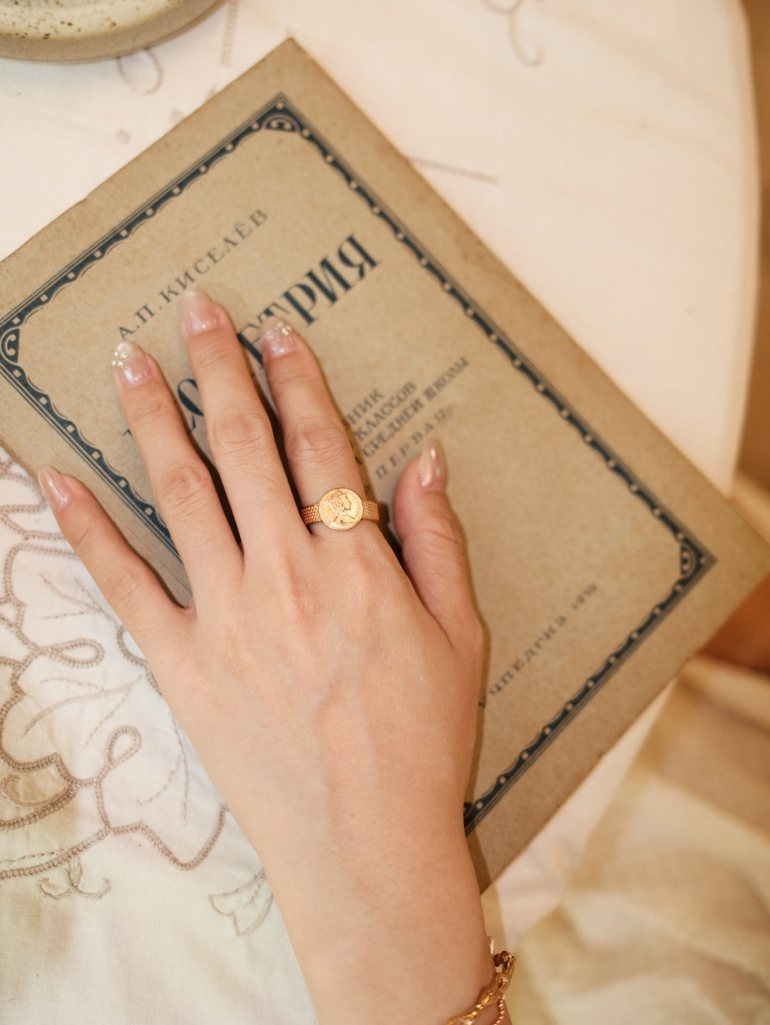 Close-up of the portrait medallion ring worn on the hand