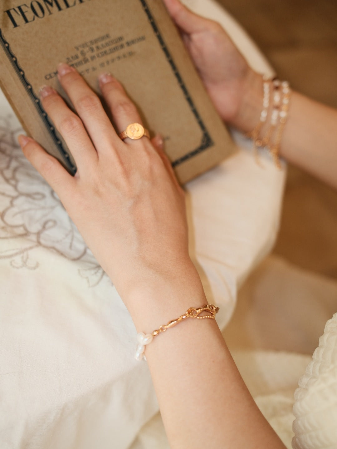Portrait medallion ring worn with separate bracelets