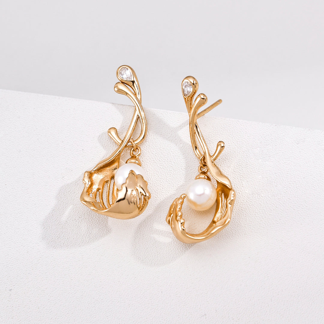 Close-up of vintage gold-tone sculptural pearl drop earrings