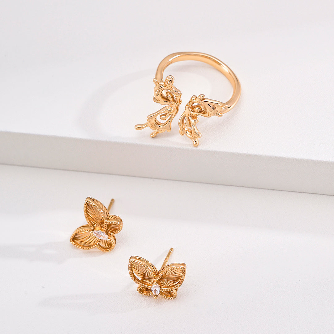 Vintage gold-tone butterfly stud earrings styled with a separate butterfly ring