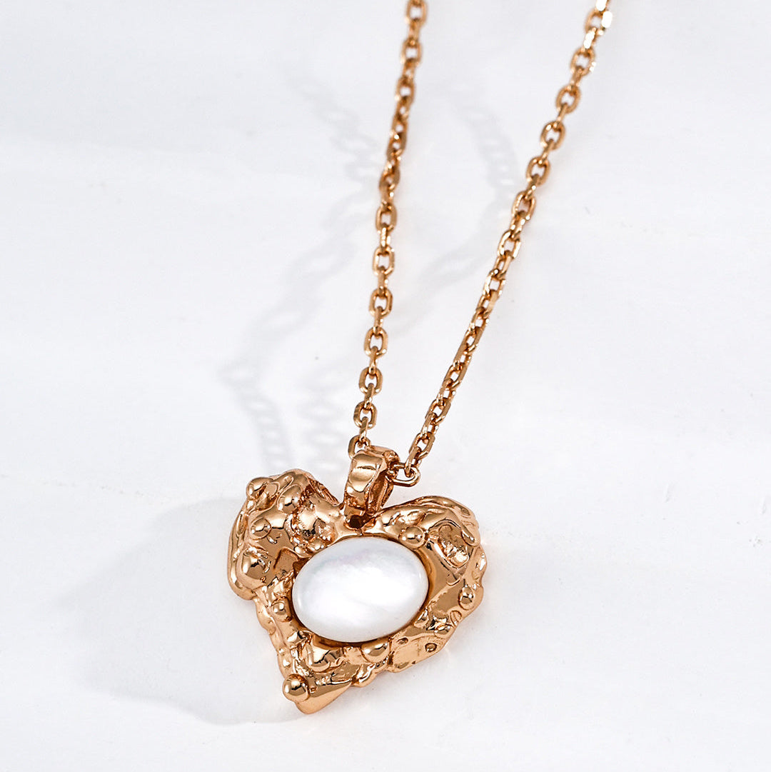 Mother-of-pearl heart pendant on a vintage gold-tone silver chain