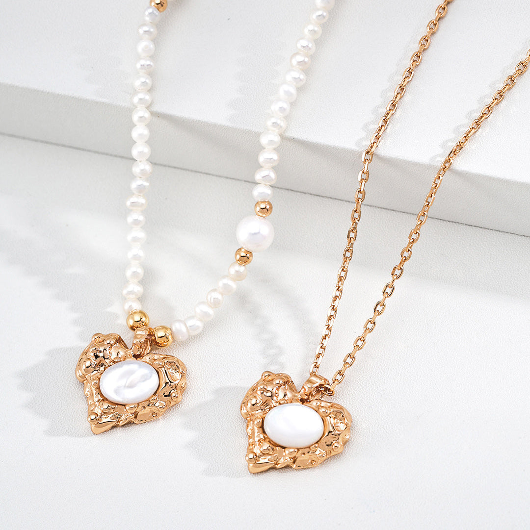 Close-up of both mother-of-pearl heart necklace styles