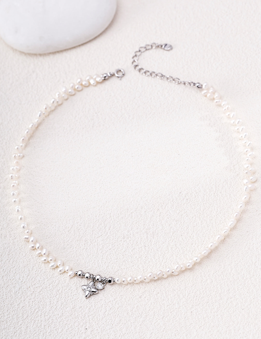 Silver-tone pearl necklace with a cross-shaped charm