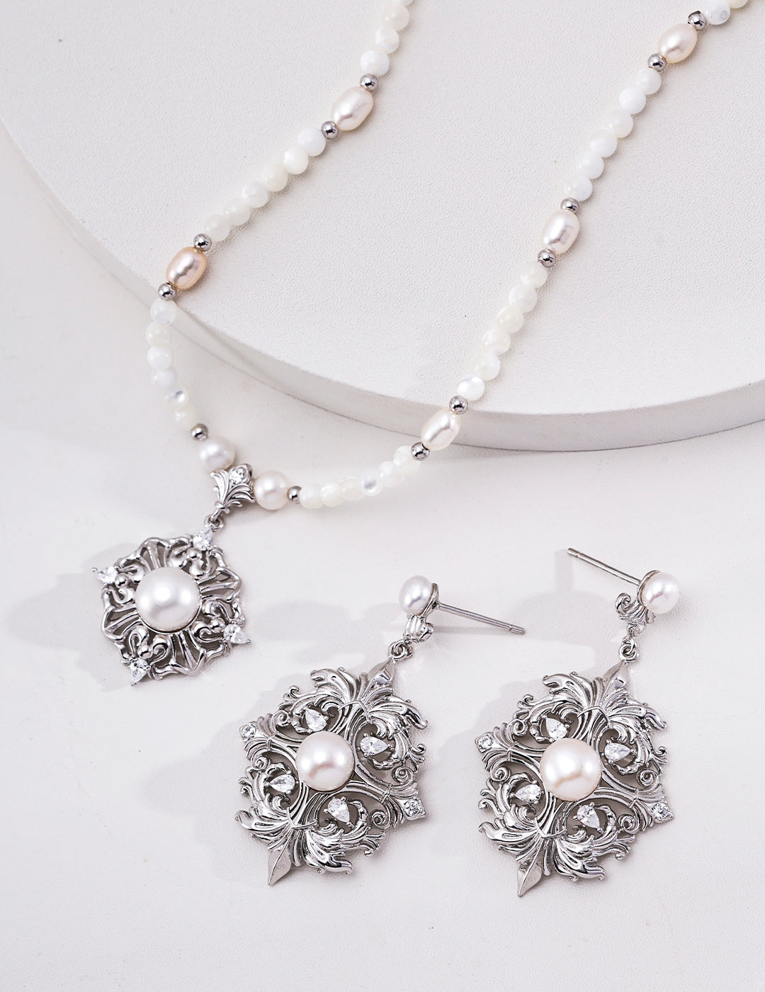 Silver-tone pearl floral medallion necklace styled with matching earrings