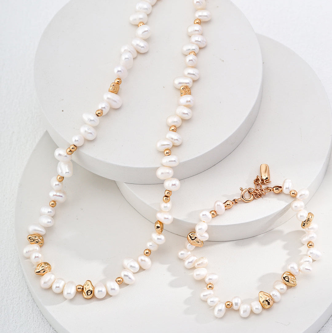 Pearl and gold-tone bead necklace beside a coordinating bracelet sold separately
