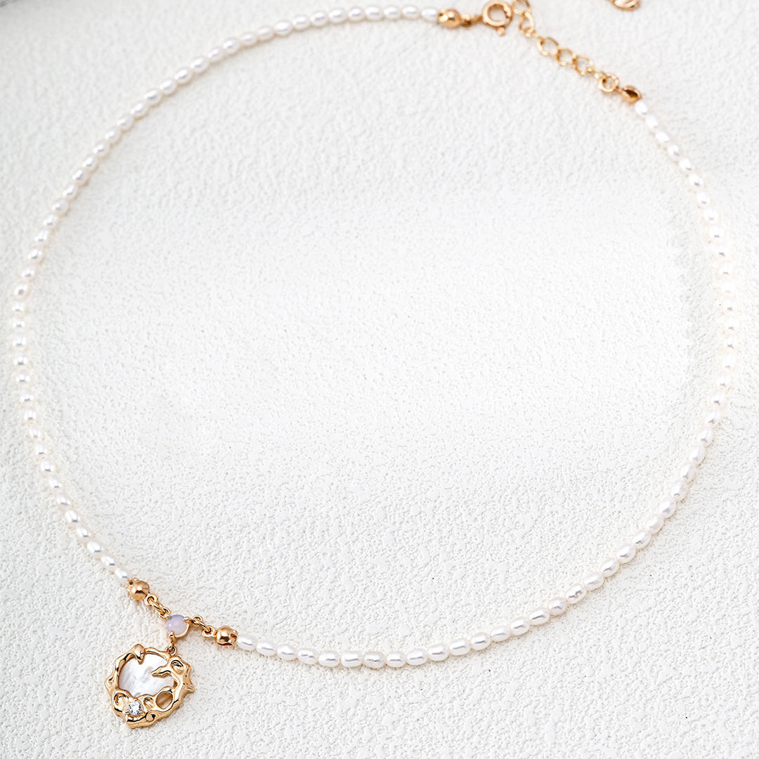 Fine pearl necklace with a vintage gold-tone openwork pendant